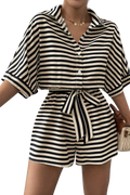 Black and white striped romper with a belt worn by a person on a white background