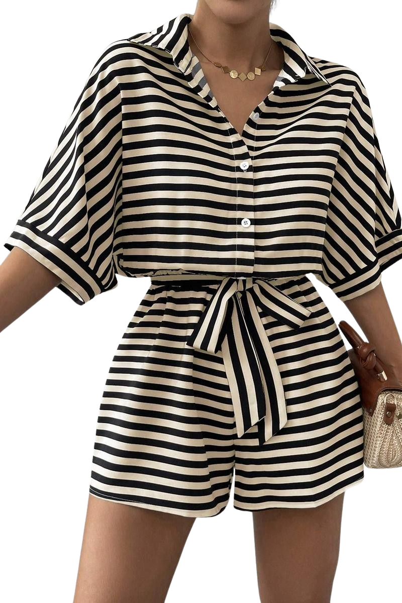 Black and white striped romper with a belt worn by a person on a white background