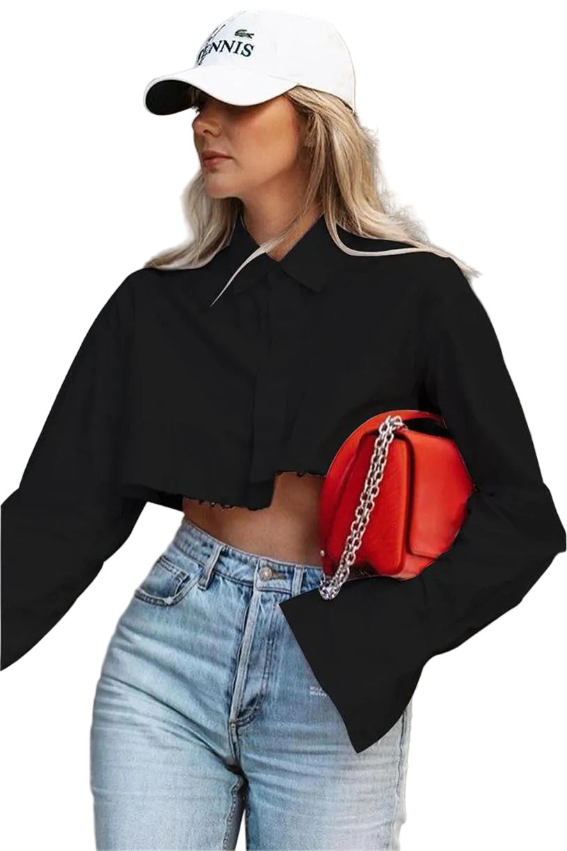 Woman wearing a black cropped jacket, blue jeans, and a white cap with a red bag.