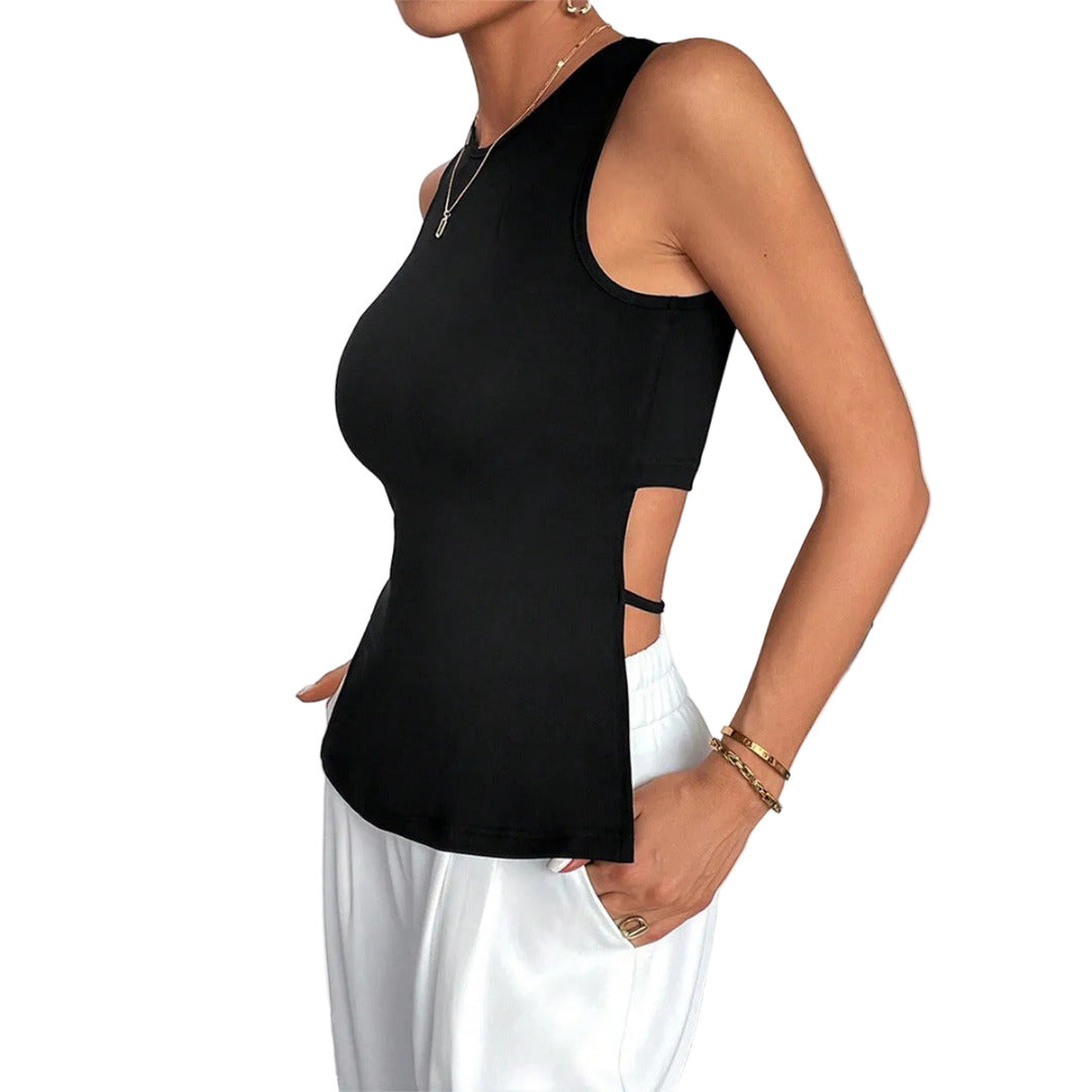 Person wearing a black sleeveless top and white pants against a neutral background