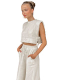 Woman in a white outfit standing 
