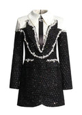 Black and white dress with embellishments on a white background