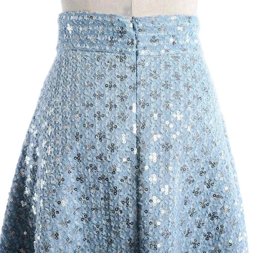 Close-up of a blue sequin skirt on a mannequin against a gray background