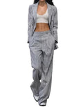 Model wearing a gray pinstripe suit on a white background