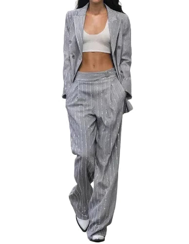 Model wearing a gray pinstripe suit on a white background