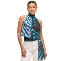 Woman wearing a blue and black patterned scarf with a beige background