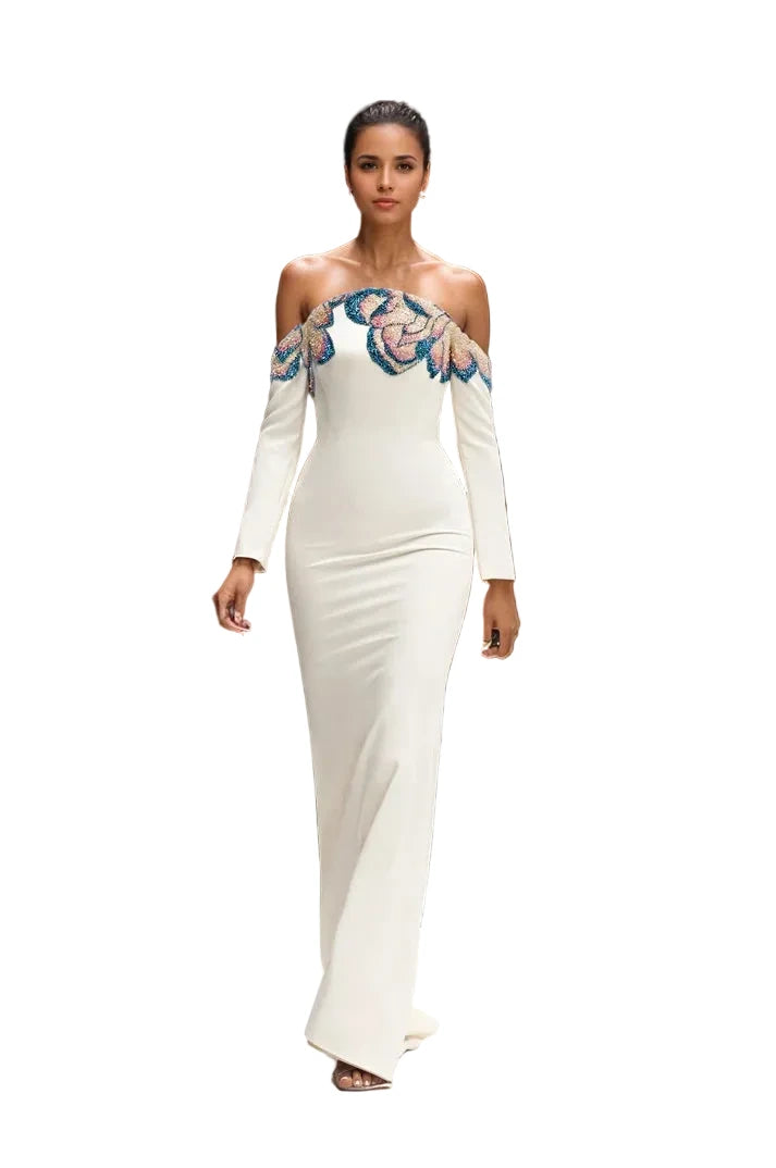 Model wearing a white off-shoulder dress with blue floral details
