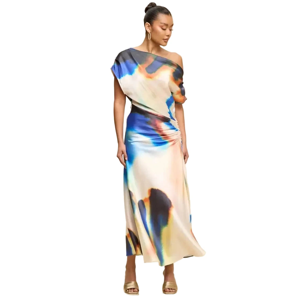 Woman wearing a colorful one-shoulder dress on a beige background