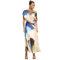Woman wearing a colorful one-shoulder dress on a beige background