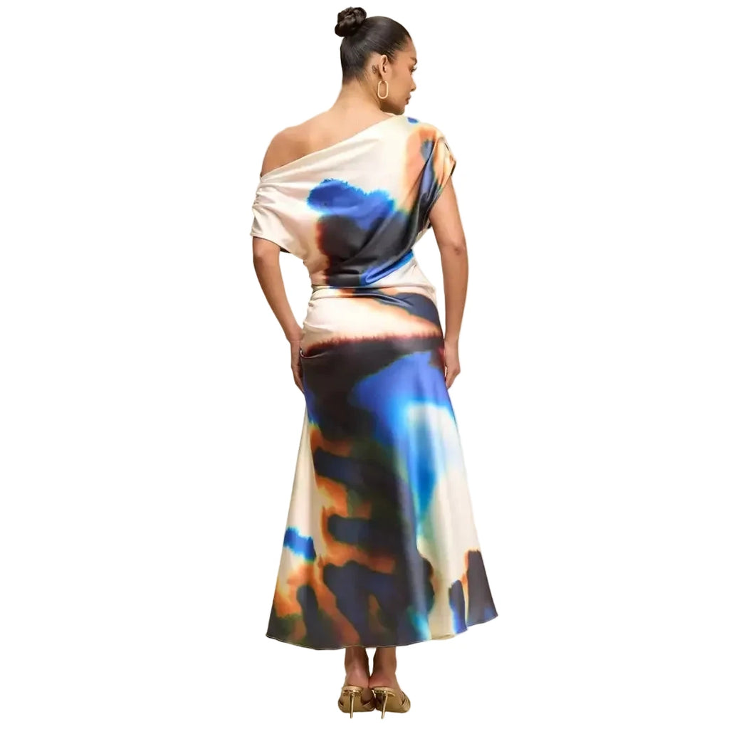 Woman wearing a colorful dress with abstract patterns on a beige background