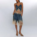 Woman wearing a blue and beige lace top with shorts on a white background
