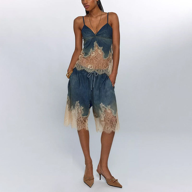 Woman wearing a blue and beige lace top with shorts on a white background