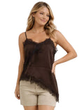 Woman wearing a brown lace-trimmed top and beige shorts on a white background