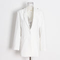 White blazer on a mannequin against a white background