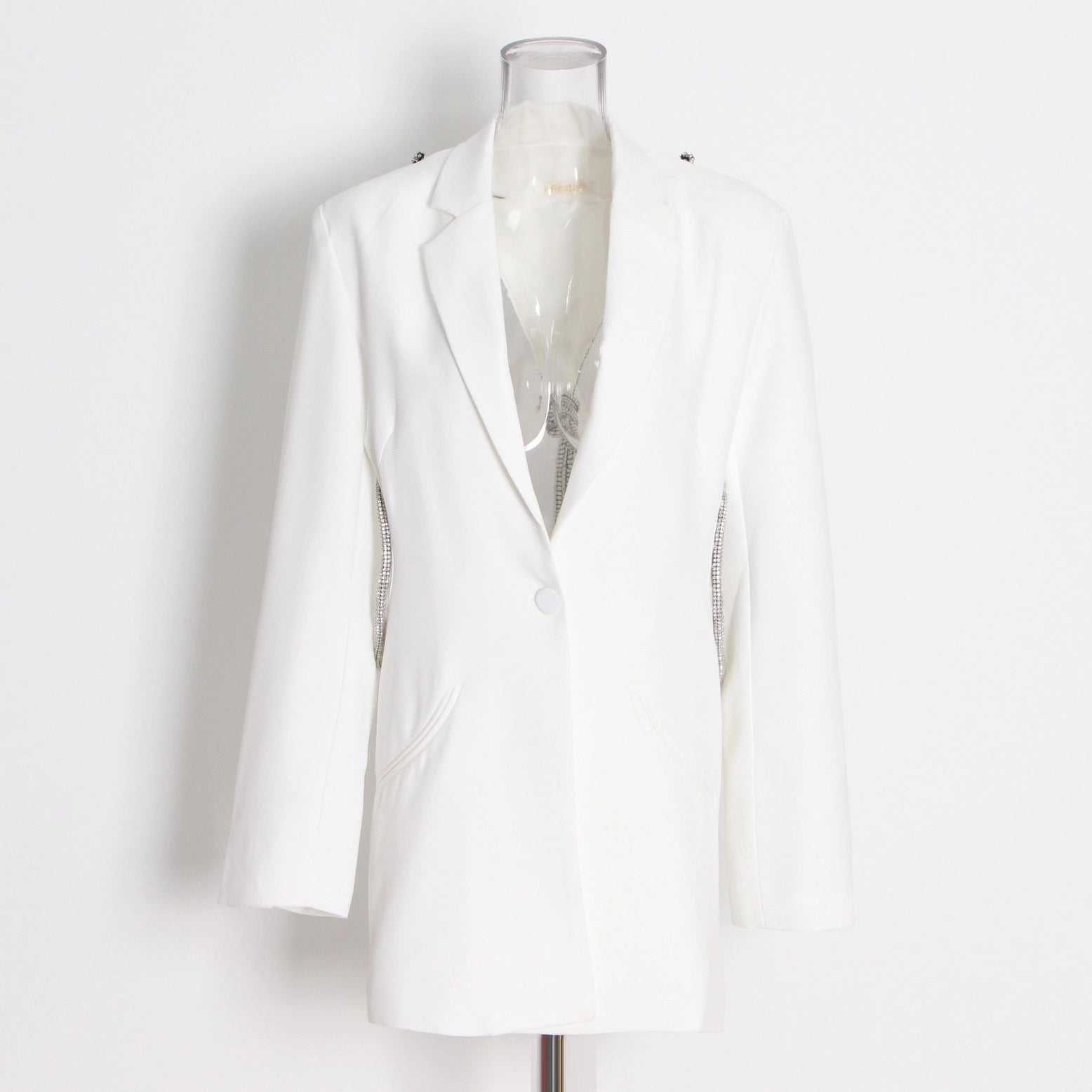 White blazer on a mannequin against a white background
